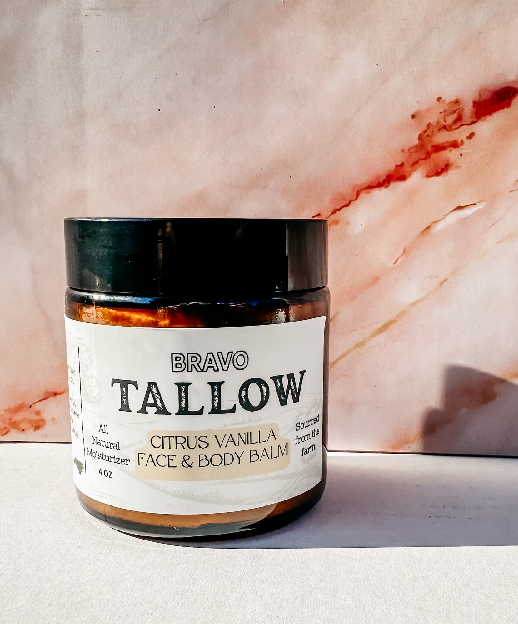 Jar of Bravo Tallow Citrus Vanilla Face & Body Balm on a marble background